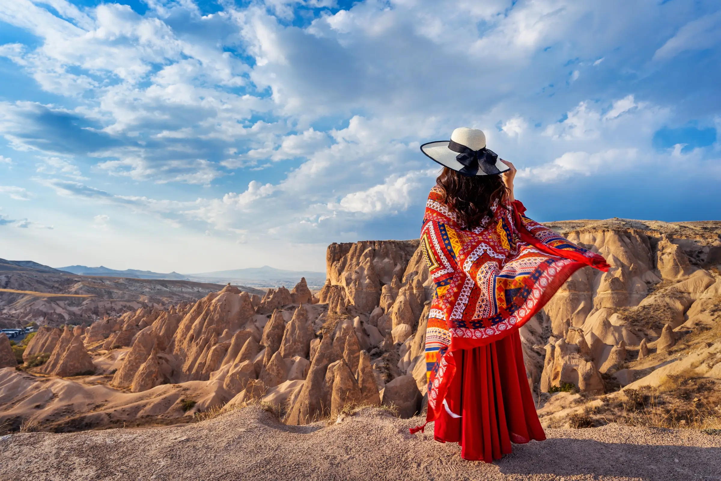 Visitor at Cappadocia Red Valley overlook on a clear afternoon — fairy chimneys panorama on a private Turkey family tour, a calm everyday scene families experience throughout the year