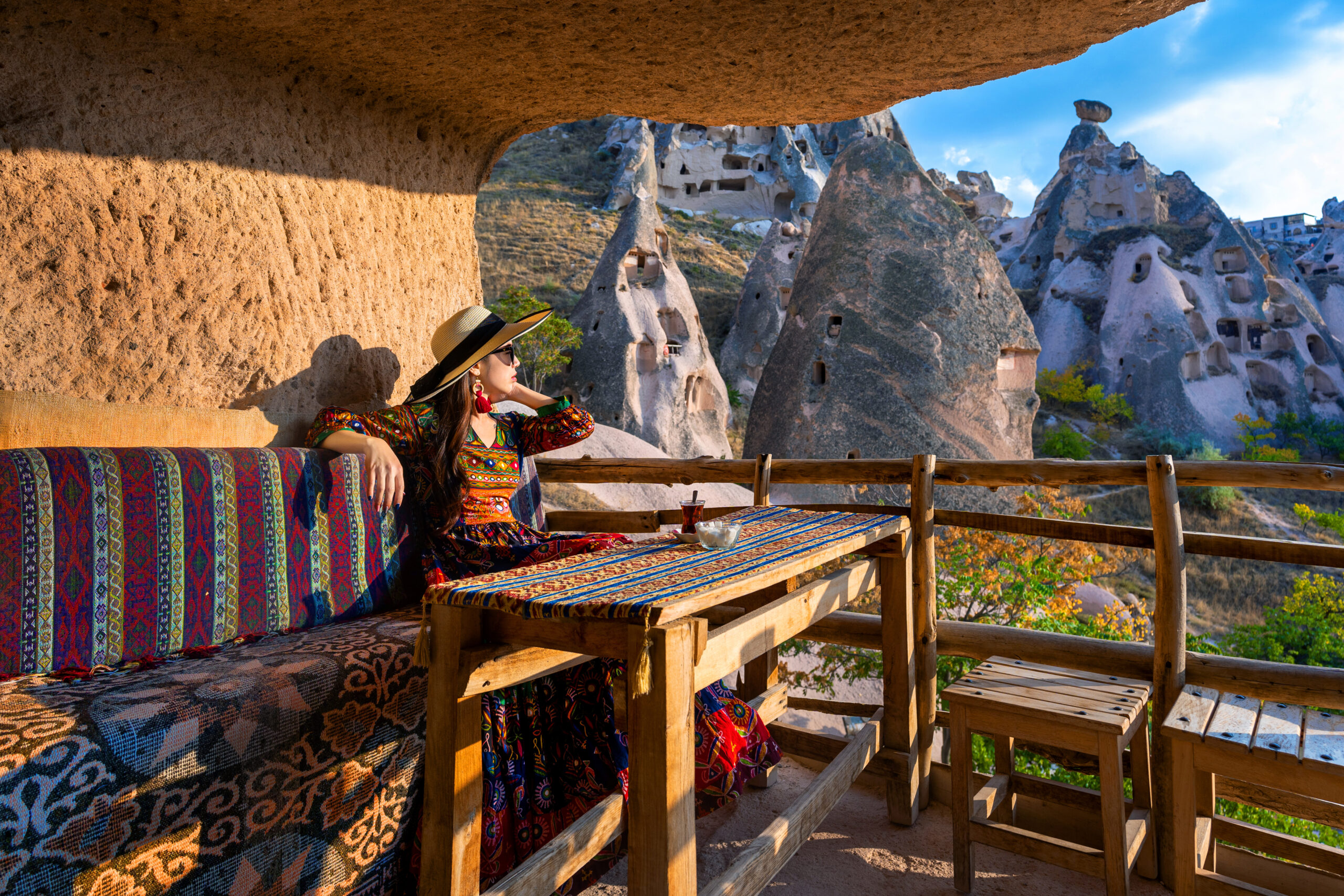 Cappadocia hot air balloon view from a cave terrace overlooking Uchisar fairy chimneys at dawn