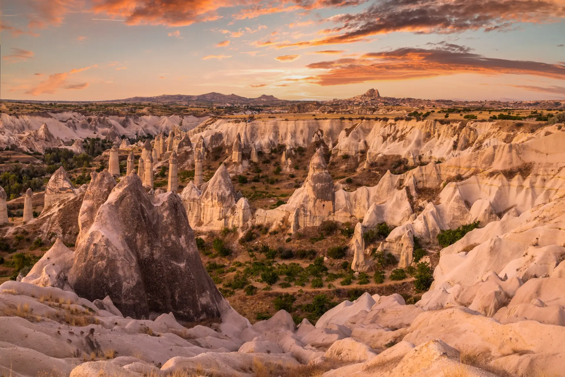 Love Valley fairy chimneys at sunset with Uçhisar Castle on the skyline, Cappadocia