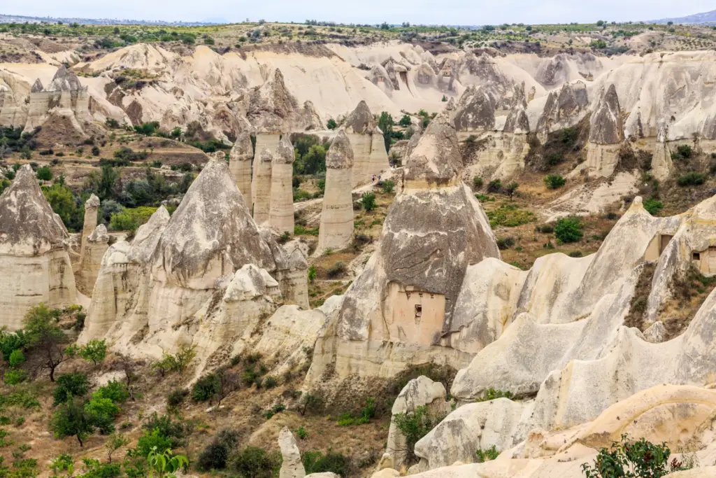 Tall cone-shaped rock pillars of Love Valley under a clear sky, Cappadocia, Turkey