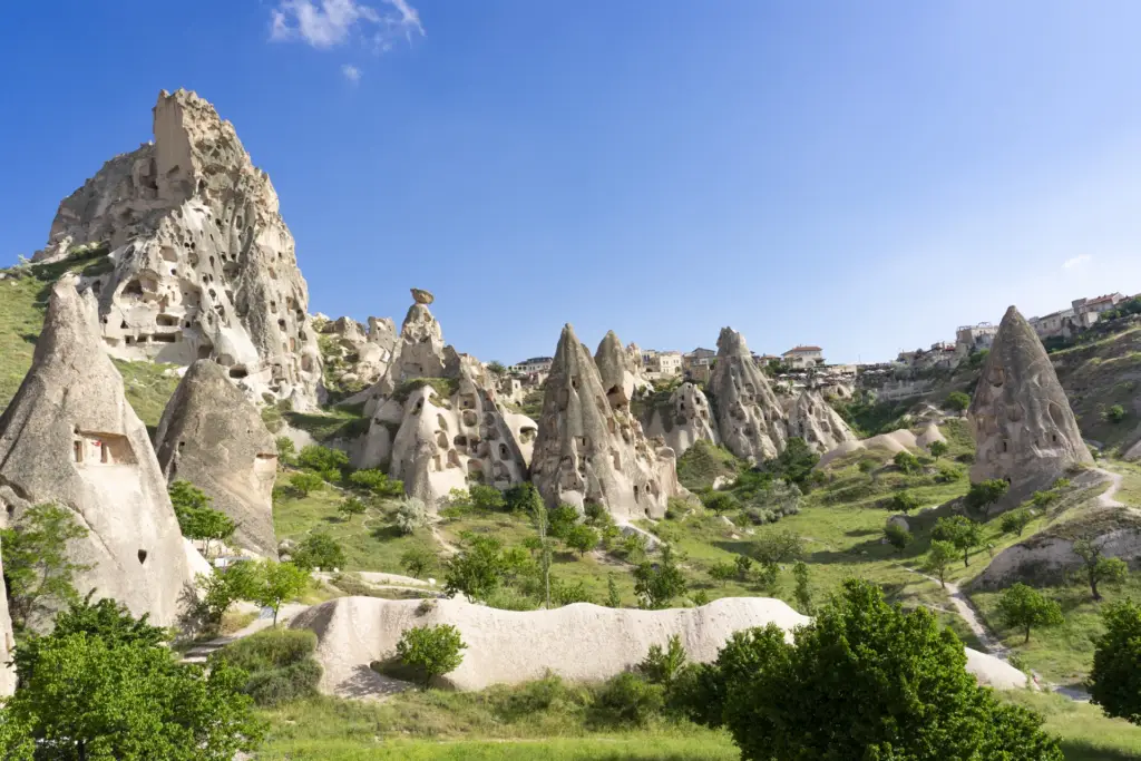 Uchisar Castle rock and cone-shaped fairy chimneys above Pigeon Valley, Cappadocia, Turkey