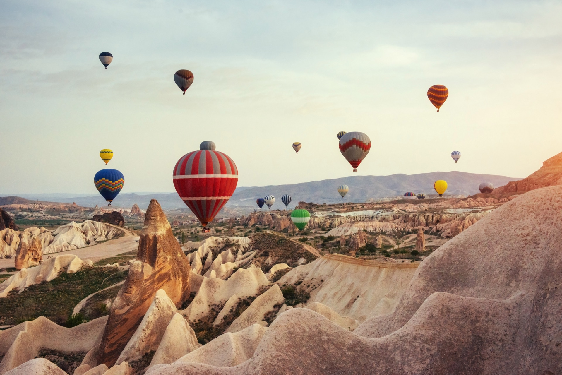 Hot air balloon flying over rock landscape at cappadocia turkey