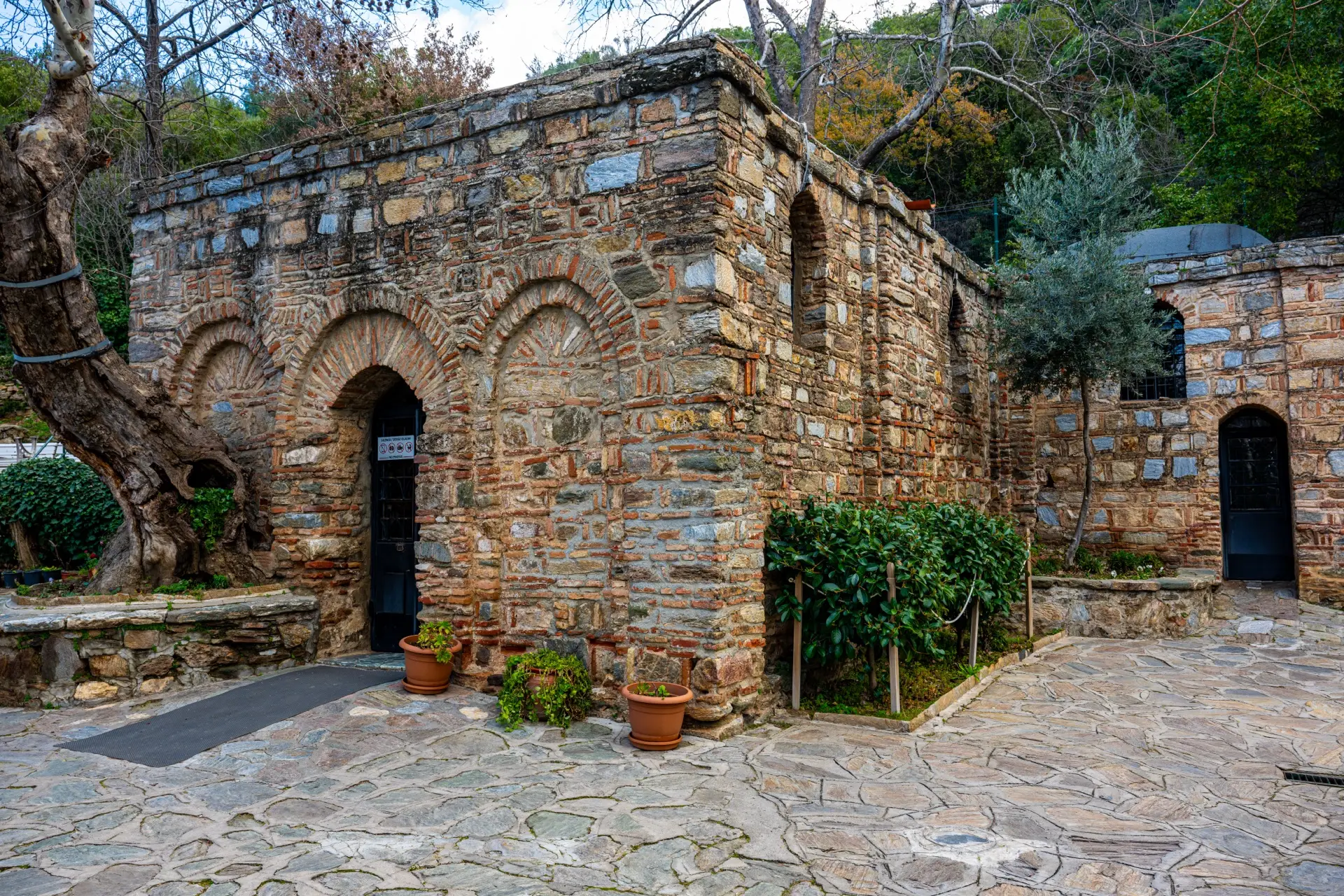 Stone village house with potted plants in the hills near Ephesus