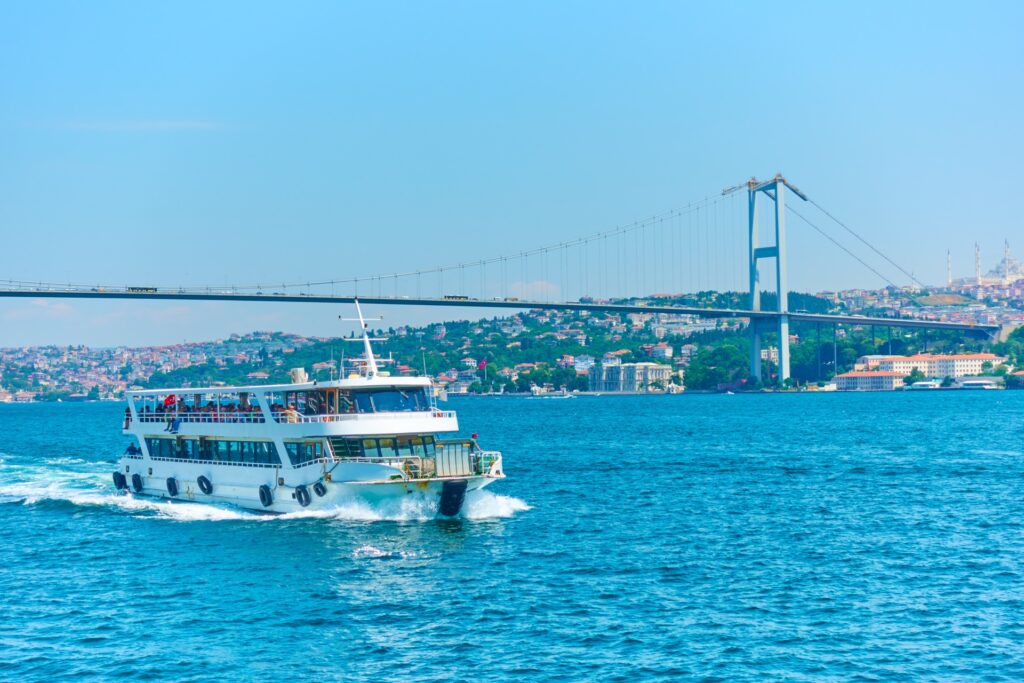 Passenger ferry crossing the Bosphorus beneath the bridge, Istanbul