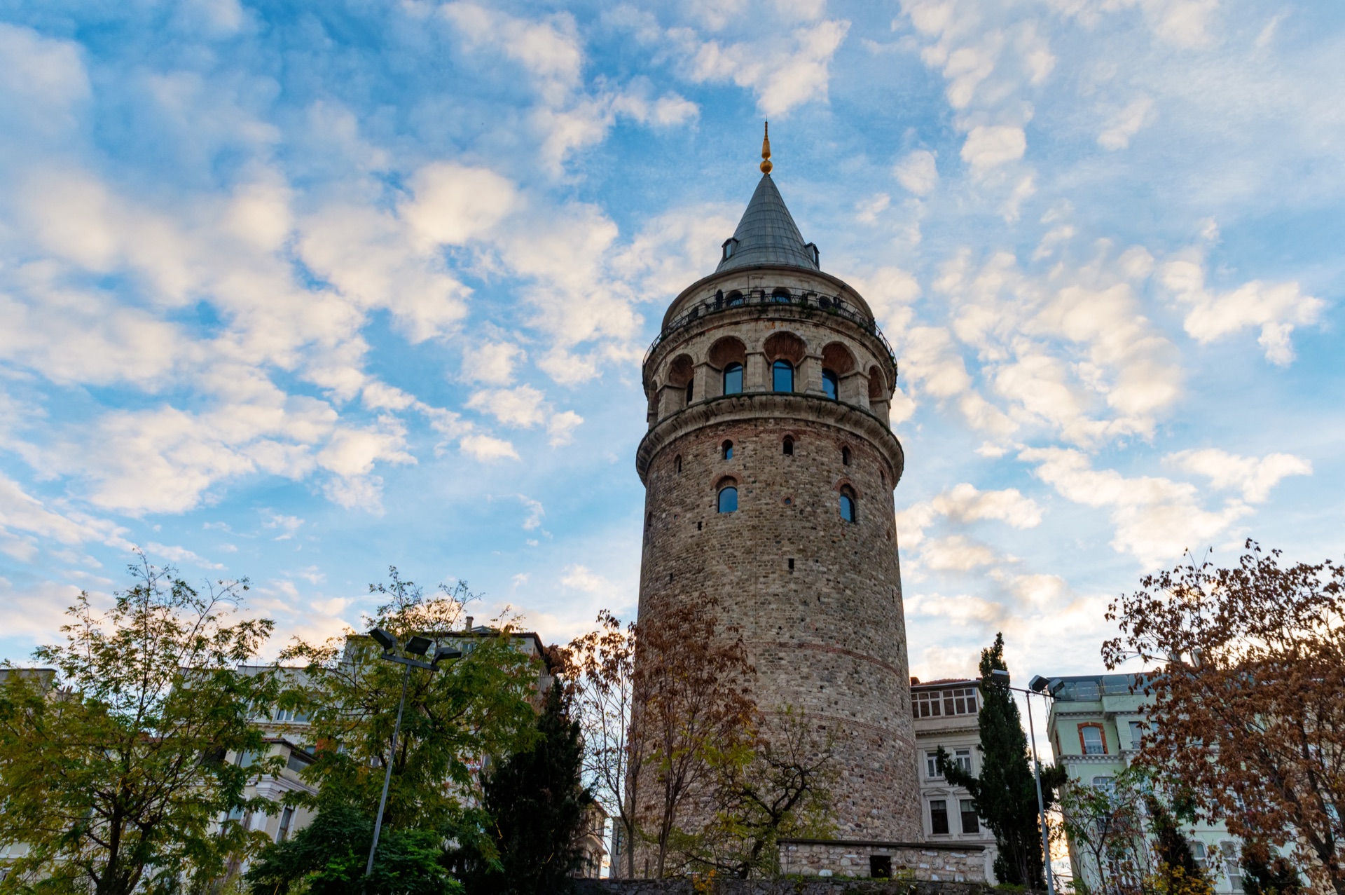 Galata Tower seen from below against a cloudy blue sky, Istanbul