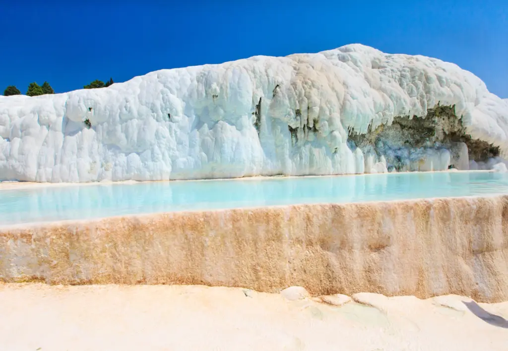White travertine terraces of Pamukkale with pale blue thermal pools