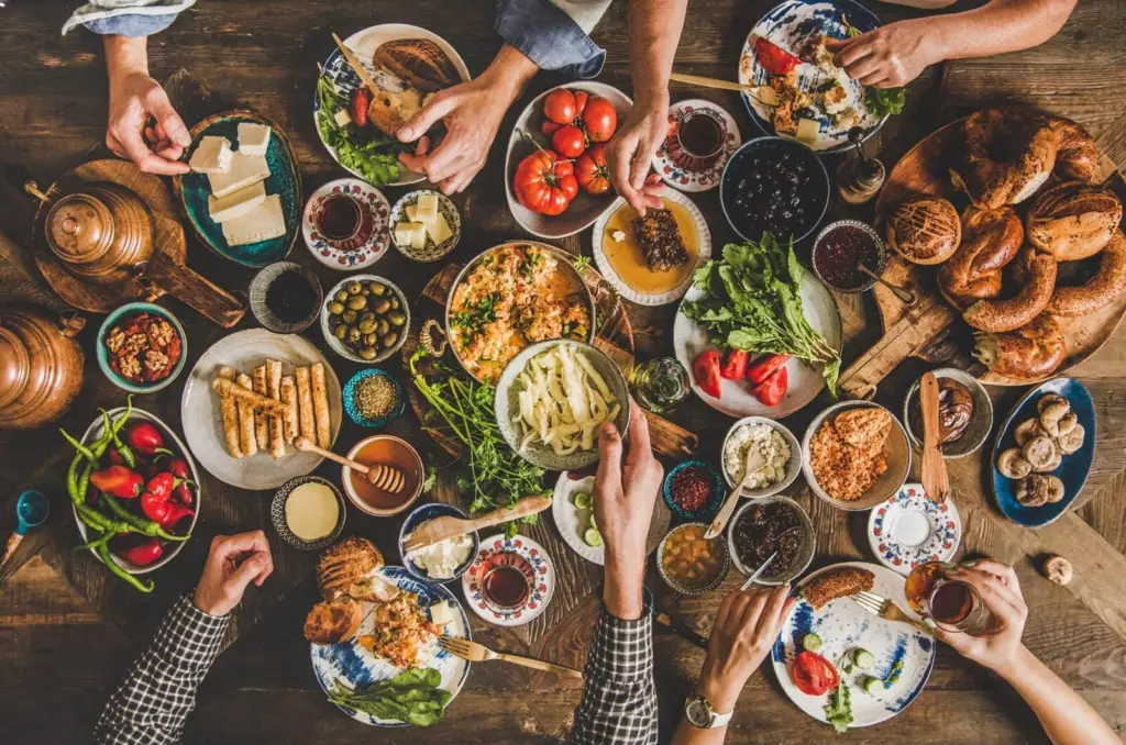 A family-sized Turkish breakfast of cheeses, olives, jams, eggs and bread on a table in Istanbul